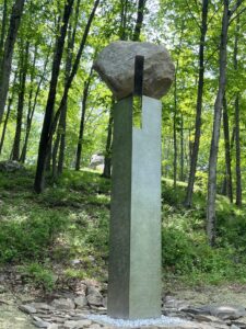 A tall column suspending a boulder.
