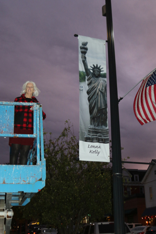 Lonna Kelly in bucket elevated to her banner night sky