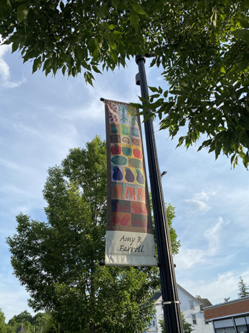 Amy R Farrell banner against green leafy trees and sky