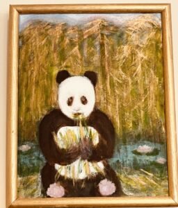 Panda enjoying bamboo lunch among the bamboo trees.