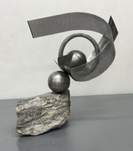 multiple pieces of metal shapes on stone