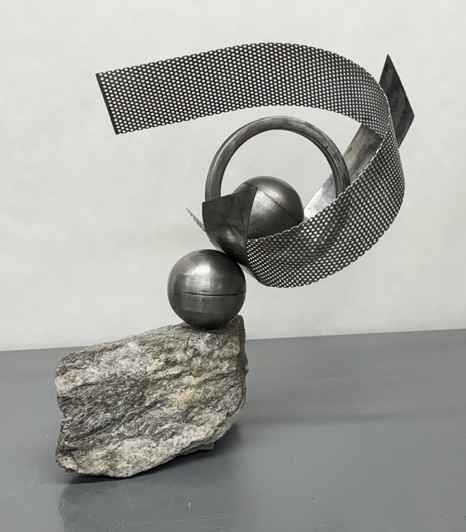 multiple pieces of metal shapes on stone