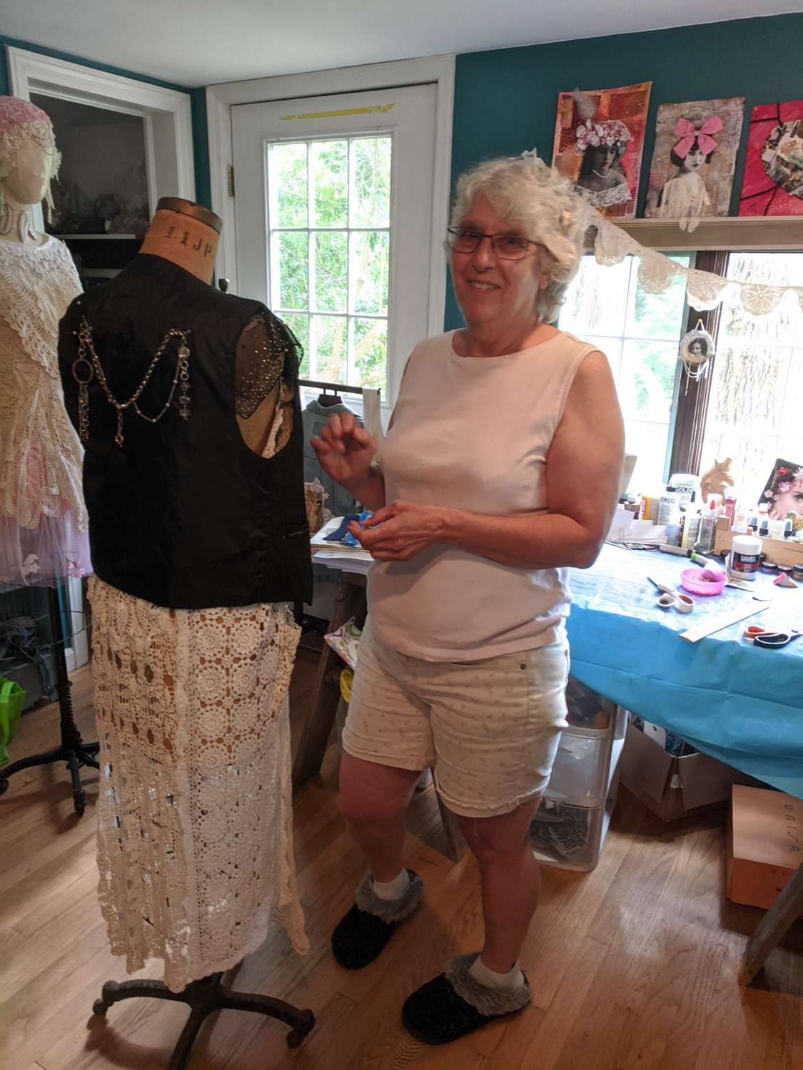 fiber artist standing and creating garment for manniken