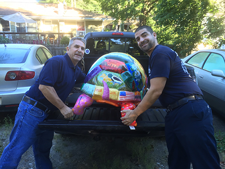 Ammaturo's lifting Artea into the back of a pickup