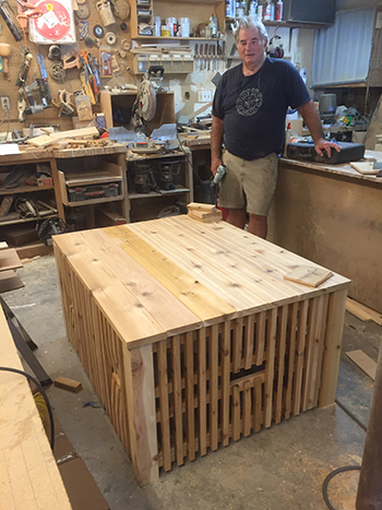 Greg Chadwick in workshop with wooden stand for Artea