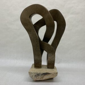 Two interlocked soapstone mobius strips carved from boulder