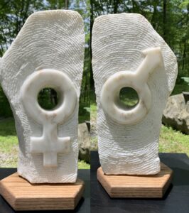 obverse and reverse views of white marble piece with Man/Woman symbols