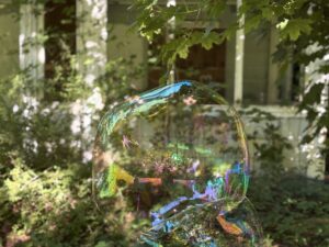 iridescent orb approaches building