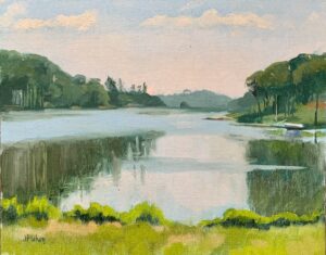 Expanse of water with forrested land in mid-distance. Reflections and eﬀect of breeze on water surface.