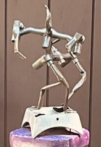 Household copper pipes recycled, reshaped, and polished to denote appreciation for indoor plumbing and all household amenities