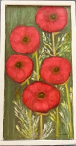 Five red poppies with a greenish, leafy background.