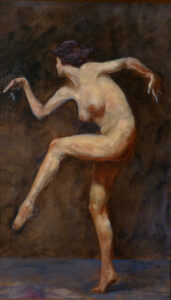 Female nude in the act of dancing against dark background