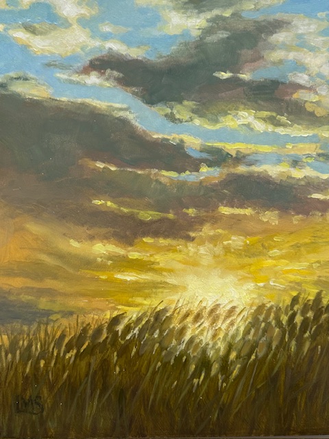 summer growth in field blows with the wind sun just rests below the lever of the wheat