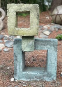 16 x 28-inch cement sculpture. Small square floating over a larger square with blue and yellow finish