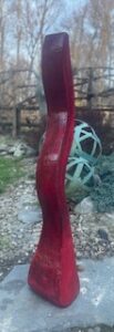 33 x 5-inch wavy cement sculpture with an antique red finish.