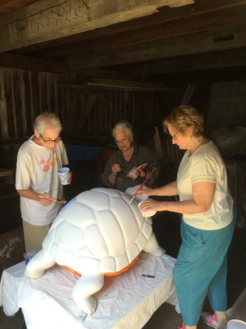 Painting in barn three artists begin the shell