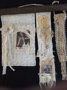mixed media– vintage material hanging from a vintage piano piece evoking another era