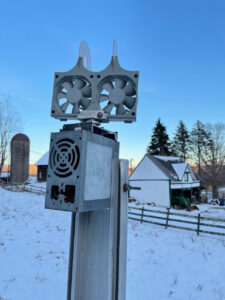 kinetic sculpture of recycled computer parts placed in an outdoor environment